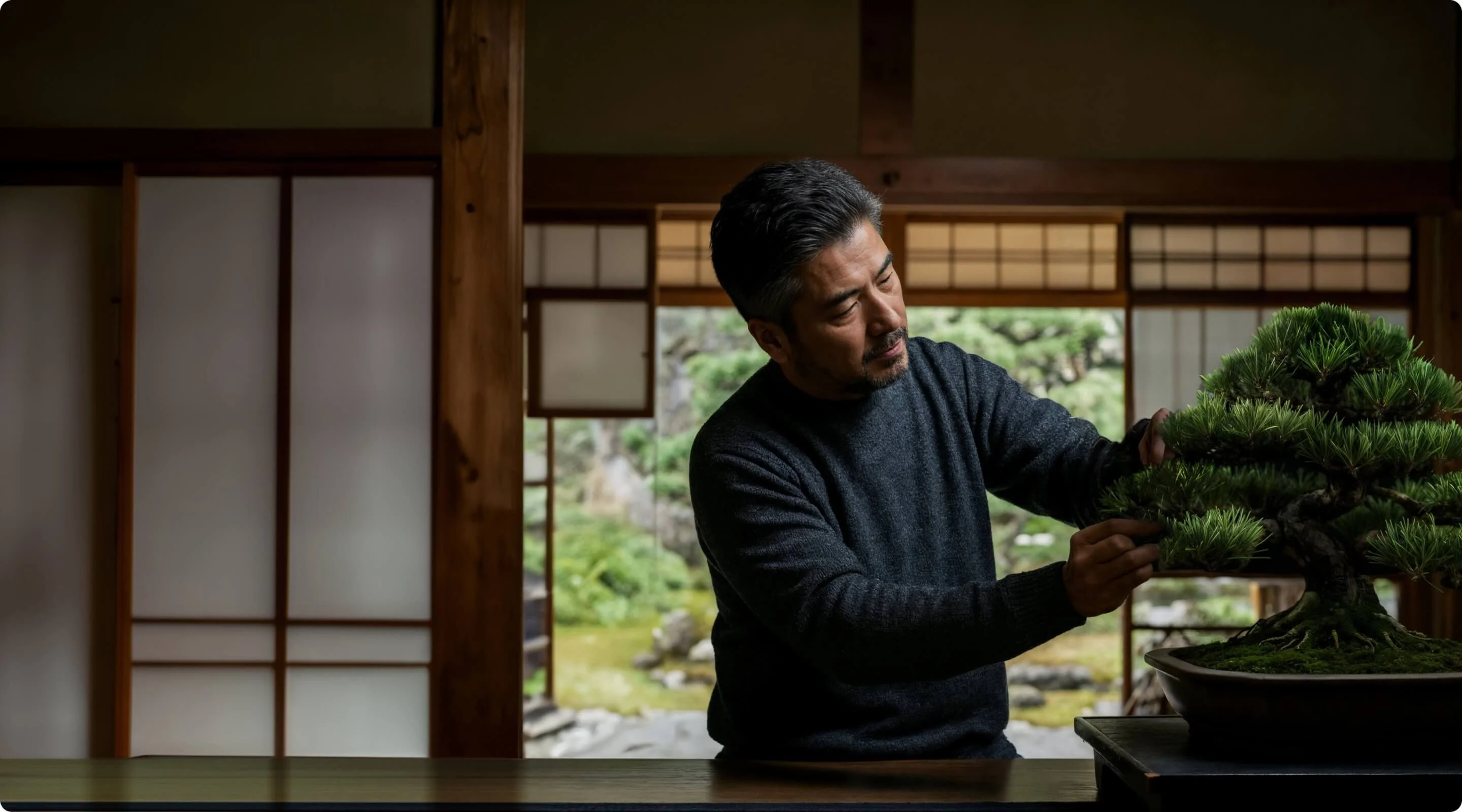 Asian man with bonsai